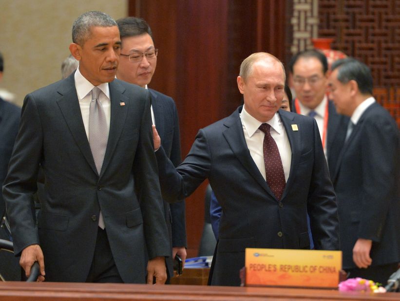 Russian President Vladimir Putin, right, passes U.S. President Barack Obama at the Asia-Pacific Economic Cooperation summit in Beijing on Tuesday, November 11. Putin had brief conversations with the leaders of Vietnam, Indonesia, Australia and the United States during breaks between official APEC summit events.