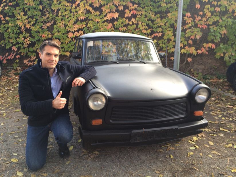 CNN's Frederik Pleitgen poses next to a Trabant, before it was painted and signed by thousands. The vehicle has been an icon to Germans ever since the tiny Communist-built cars started rolling across the border between what was then East and West Germany in 1989. 