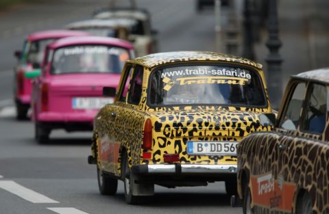 Tourists drive Trabant cars on a guided tour through the city center on September 19, 2013 in Berlin, Germany. Several companies now offer tours with the cars. 
