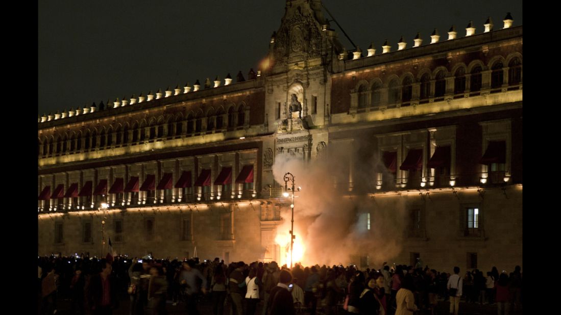 Protesters set fire to the main entrance of the Mexican National Palace during a demonstration in Mexico City on Saturday, November 8. 