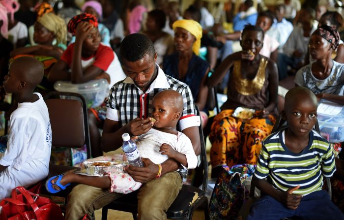 A child who survived the Ebola virus is fed by another survivor at Hastings treatment center on the outskirts of Freetown. The pair are at a ceremony where 63 survivors were discharged on November 11.