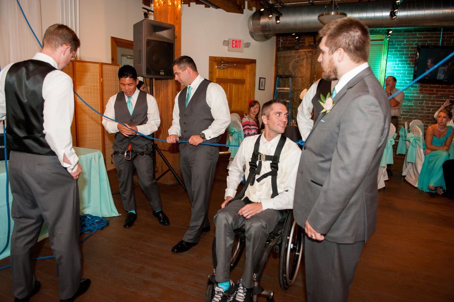 Joey Johnson uses a wheelchair but wanted to surprise his bride by standing for their first dance, so he asked his groomsmen to help rig up a contraption that would let him stand during the song.
