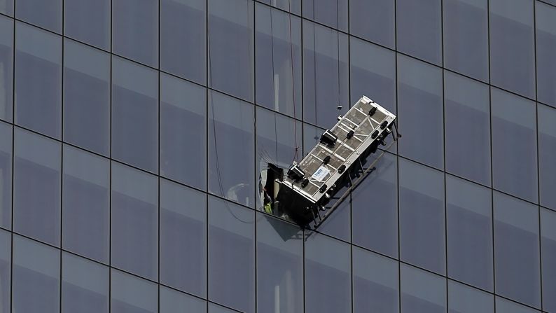 Rescue workers used a diamond saw to tear through three layers of glass panes -- the thickest nearly 2 inches -- in order to pull the workers to safety about 2:15 p.m., authorities said.