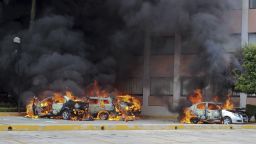 Cars burn in front of the state congress building after protesting teachers torched them in the state capital city of Chilpancingo, Mexico, Wednesday Nov. 12, 2014. Violent protests over the disappearance of 43 college students continue and are now threatening tourism in the nearby resort city of Acapulco ahead of a major holiday weekend when Mexicans traditionally flock to the beach, business leaders said Wednesday. Investigators say the 43 students from a rural teachers college were rounded up by local police, turned over to a drug gang and apparently killed, their corpses charred into ash and dumped into a river. (AP Photo/Alejandrino Gonzalez)