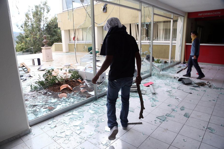 Protesters damage the headquarters of the Institutional Revolutionary Party on November 12 in Morelia, Mexico. The Iguala incident has sparked protests across Mexico. 