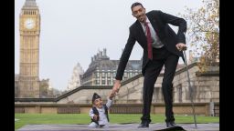 Chandra Bahadur Dangi, from Nepal, (L) the shortest adult to have ever been verified by Guinness World Records, poses for pictures with the world's tallest man Sultan Kosen from Turkey, during a photocall in London on November 13, 2014, to mark Guinness World Records Day. Chandra Dangi, measures a tiny 21.5in (0.54m)  the same height as six stacked cans of beans. Sultan Kosen measures 8 ft 3in (2.51m).  AFP PHOTO / ANDREW COWIE        (Photo credit should read ANDREW COWIE/AFP/Getty Images)