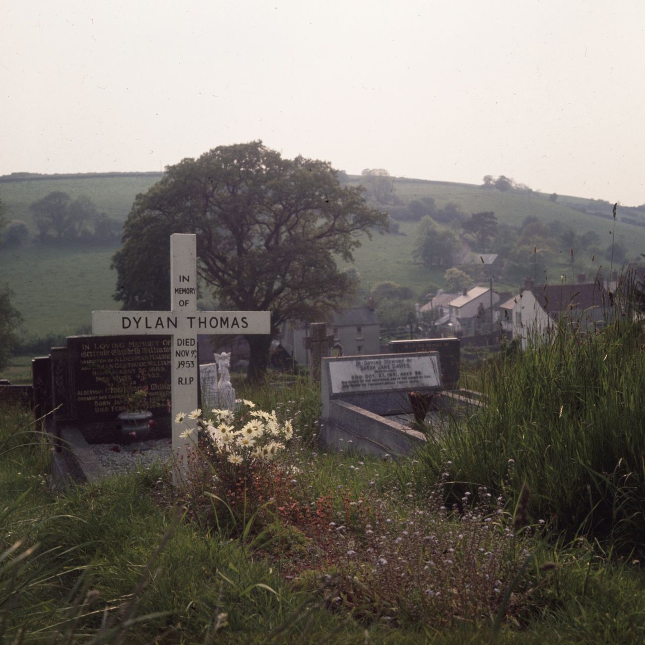 His body was brought back to Laugharne, the south Wales village which had inspired many of his most famous works, and he was buried in the local churchyard (pictured in 1969).