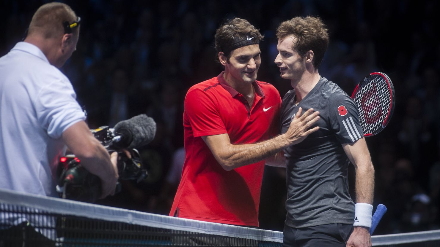 Roger Federer consoles Andy Murray after the Swiss blew the Scot away in a virtuoso display. 