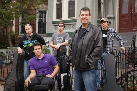 Bloom and some members of MusiCorps pose in front of Bloom's home in Washington. 