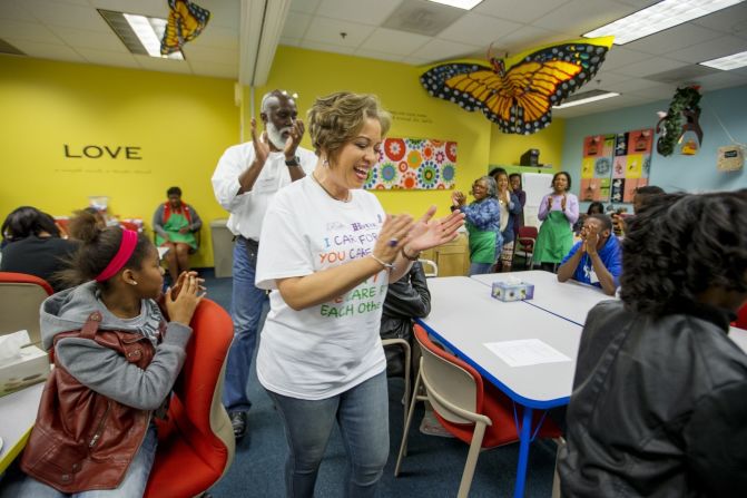 Program participants and volunteers chant at the start of a Roberta's House peer support session in Baltimore. Annette March-Grier, center, founded Roberta's House to help children and their families cope with grief -- particularly the trauma of losing a loved one.