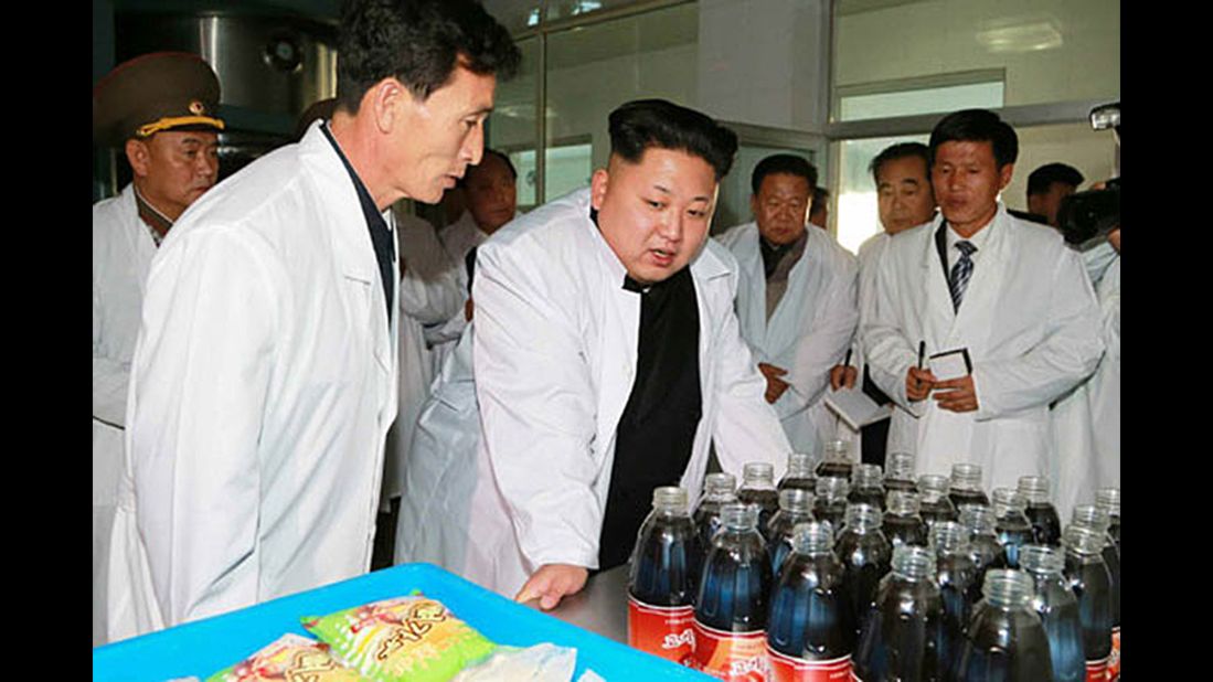 Kim Jong Un, center, leader of North Korea, inspects a model food factory in North Korea. The date of the visit is unknown. 