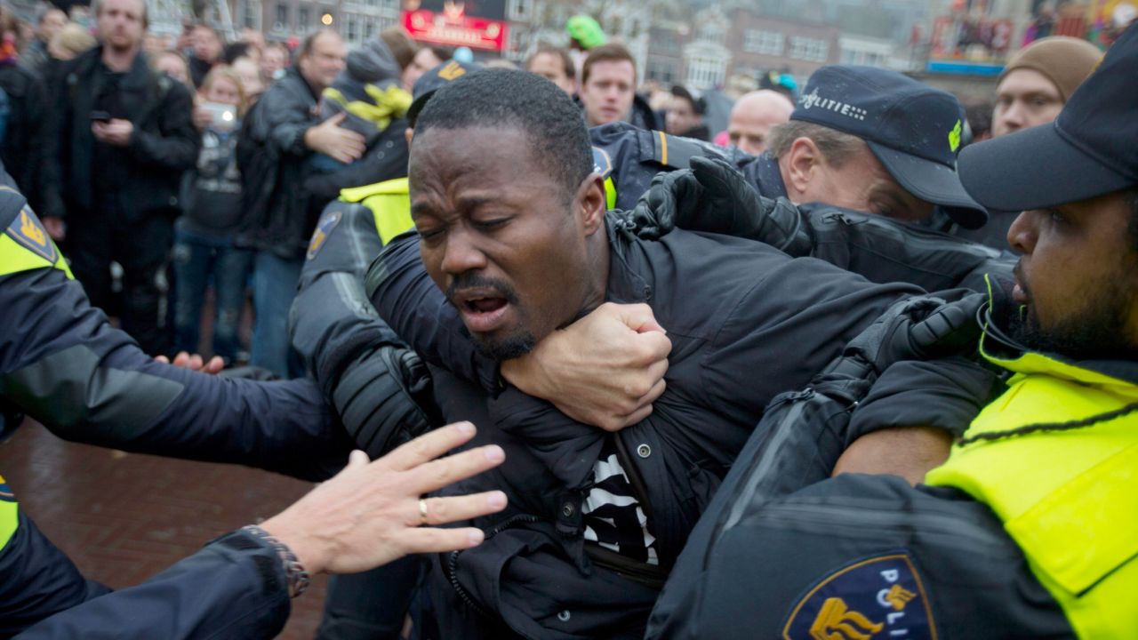 Police detain an anti-Black Pete demonstrator in Gouda, Netherlands, on Saturday.