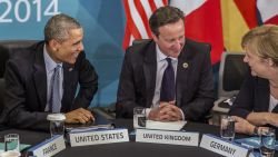 U.S. President Barack Obama and Britain's Prime Minister David Cameron listen to Germany's Chancellor Angela Merkel as they attend the Transatlantic Trade and Investment Partnership (TTIP) meeting at the G20  the G-20 leaders summit in Brisbane, Australia, Sunday, Nov. 16, 2014.