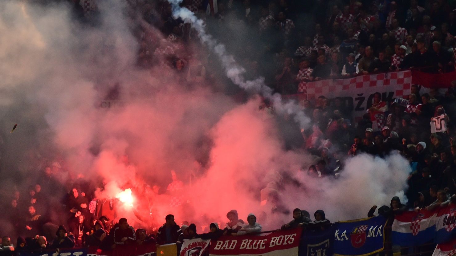 Croatian supporters throw flares on the pitch during their side's Euro 2016 qualifier against Italy at the San Siro.
