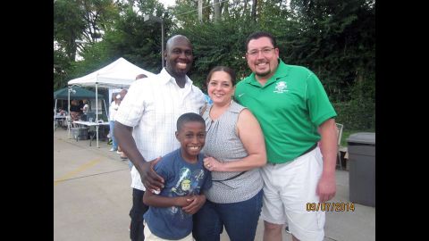 Stefannie Wheat with her husband, Ken, son Christopher and Ferguson Mayor James Knowles.