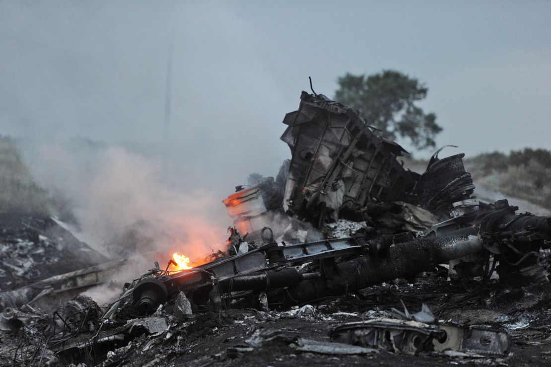 A picture taken on July 17, 2014 shows flames among the wreckage of MH17 in rebel-held eastern Ukraine.