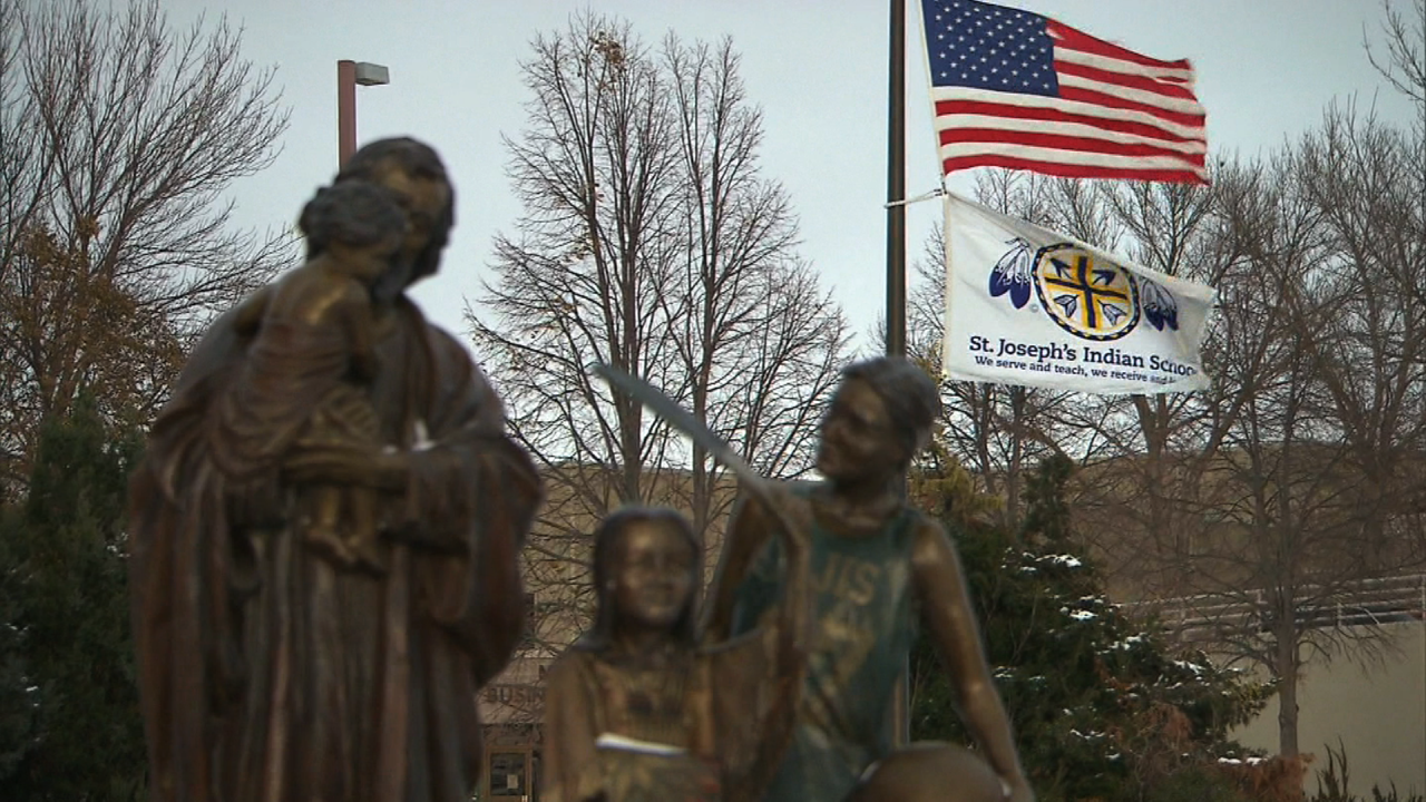 Flags fly at the entrance to St. Joseph's Indian School.