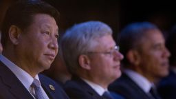 Chinese President Xi Jinping (L), Canadian Prime Minister Stephen Harper (C) and US President Barack Obama watch a welcome ceremony performed by Aboriginal and Torres Strait Island people during the G20 Summit in Brisbane on November 15, 2014. Brisbane is hosting the leaders of the world's 20 biggest economies for the G20 summit. AFP PHOTO / POOL (Photo credit should read MARK BAKER/AFP/Getty Images)