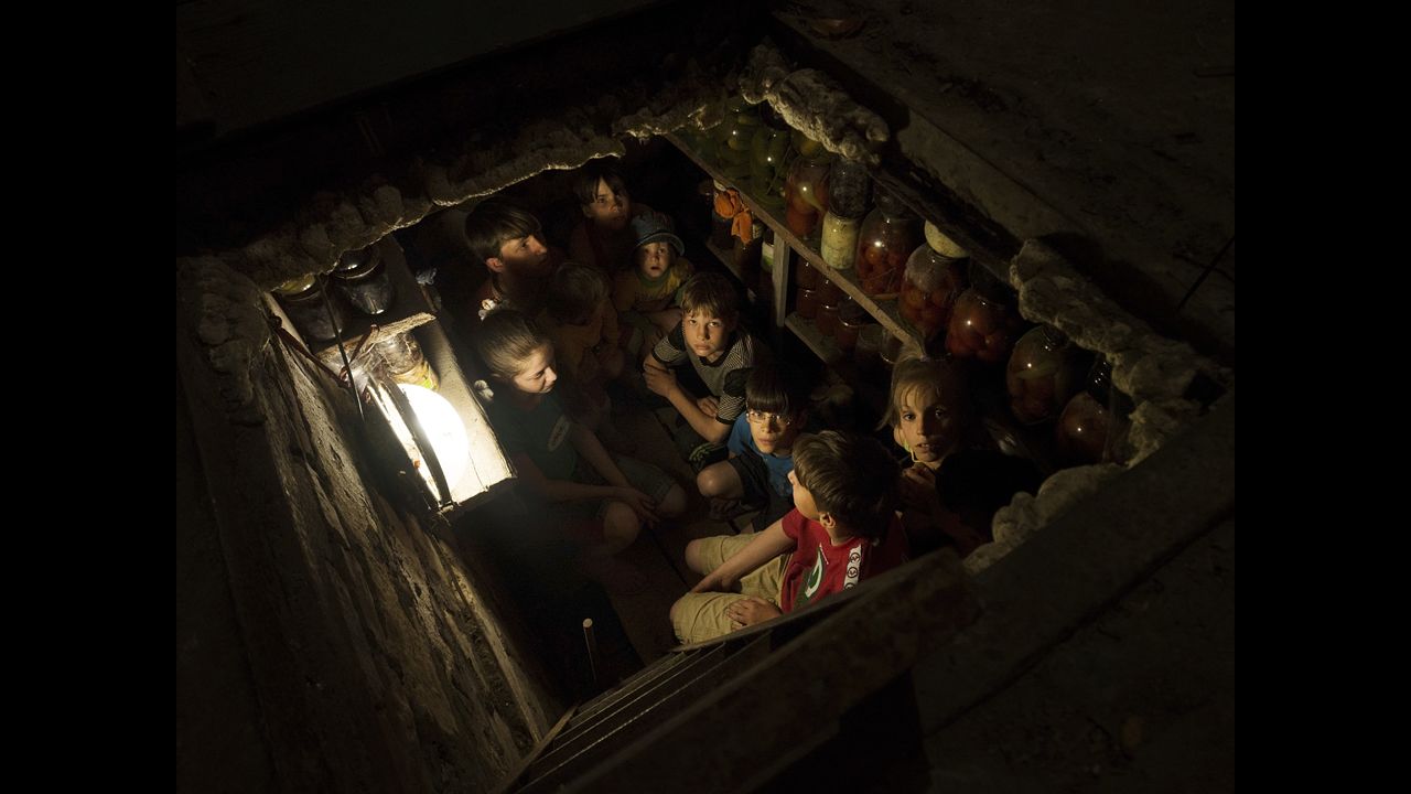 Orphaned children in Slovyansk, Ukraine, seek refuge inside a shelter's basement in May. It was one of the last photos taken by Italian photographer Andy Rocchelli, who was killed by a mortar attack.