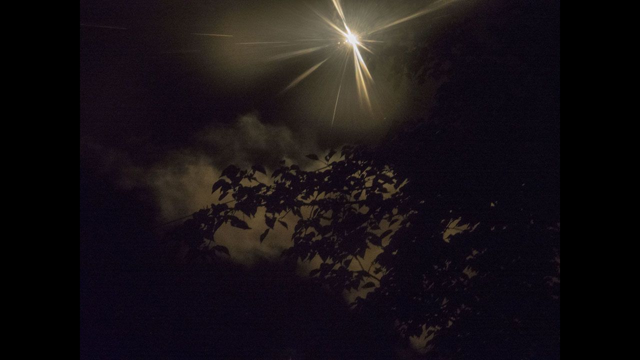 A flare is seen in the sky during overnight bombing of a neighborhood in Slovyansk.