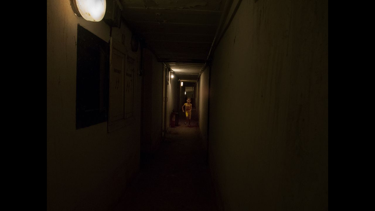 A girl runs in cellars used as a bunker in Slovyansk.