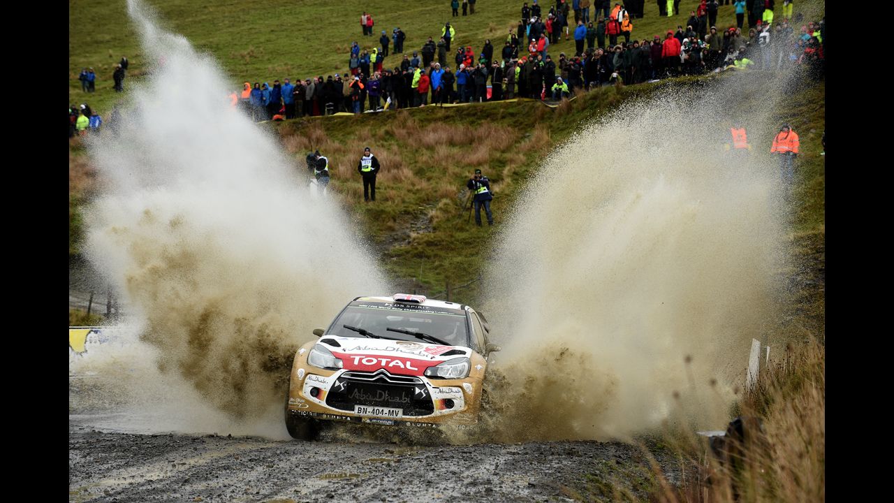 The car of Kris Meeke and Paul Nagle splashes through mud during the World Rally Championship event in Deeside, Wales, on Friday, November 14.