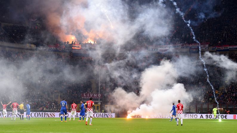 Flares are thrown onto the field by Croatia soccer fans during a Euro 2016 qualifying match Sunday, November 16, in Milan, Italy. The flares delayed the match, which eventually ended in a 1-1 draw.
