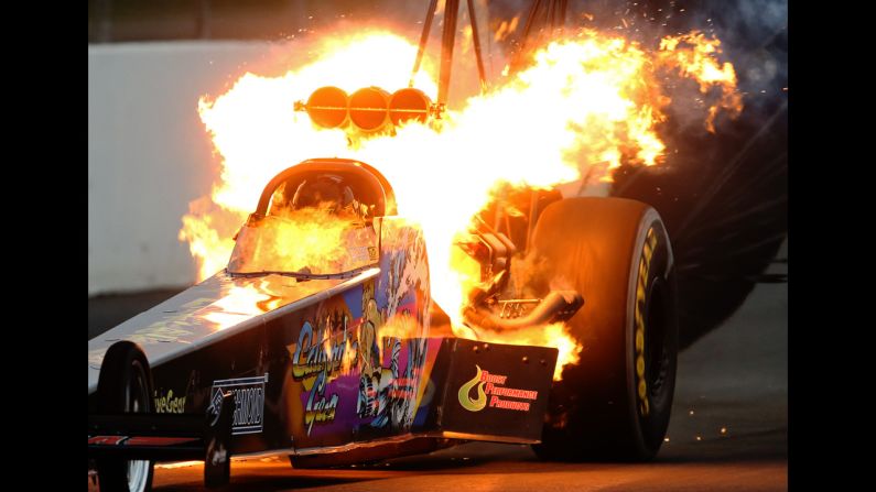 Fire is seen from the dragster of Steve Chrisman during an event in Pomona, California, on Saturday, November 15. It is not uncommon to see fire from drag racing vehicles as their engines are pushed to the limit.
