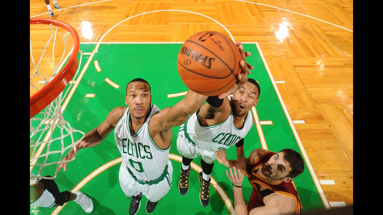 Avery Bradley, left, and Boston Celtics teammate Jared Sullinger jump for a rebound while playing Kevin Love, right, and the Cleveland Cavaliers on Friday, November 14.