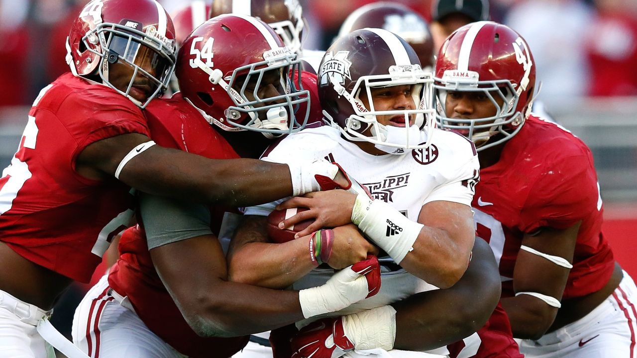 Mississippi State quarterback Dak Prescott is swarmed by Alabama defenders Saturday, November 15, in Tuscaloosa, Alabama. Alabama won the game 25-20, handing the top-ranked Bulldogs their first loss of the season.