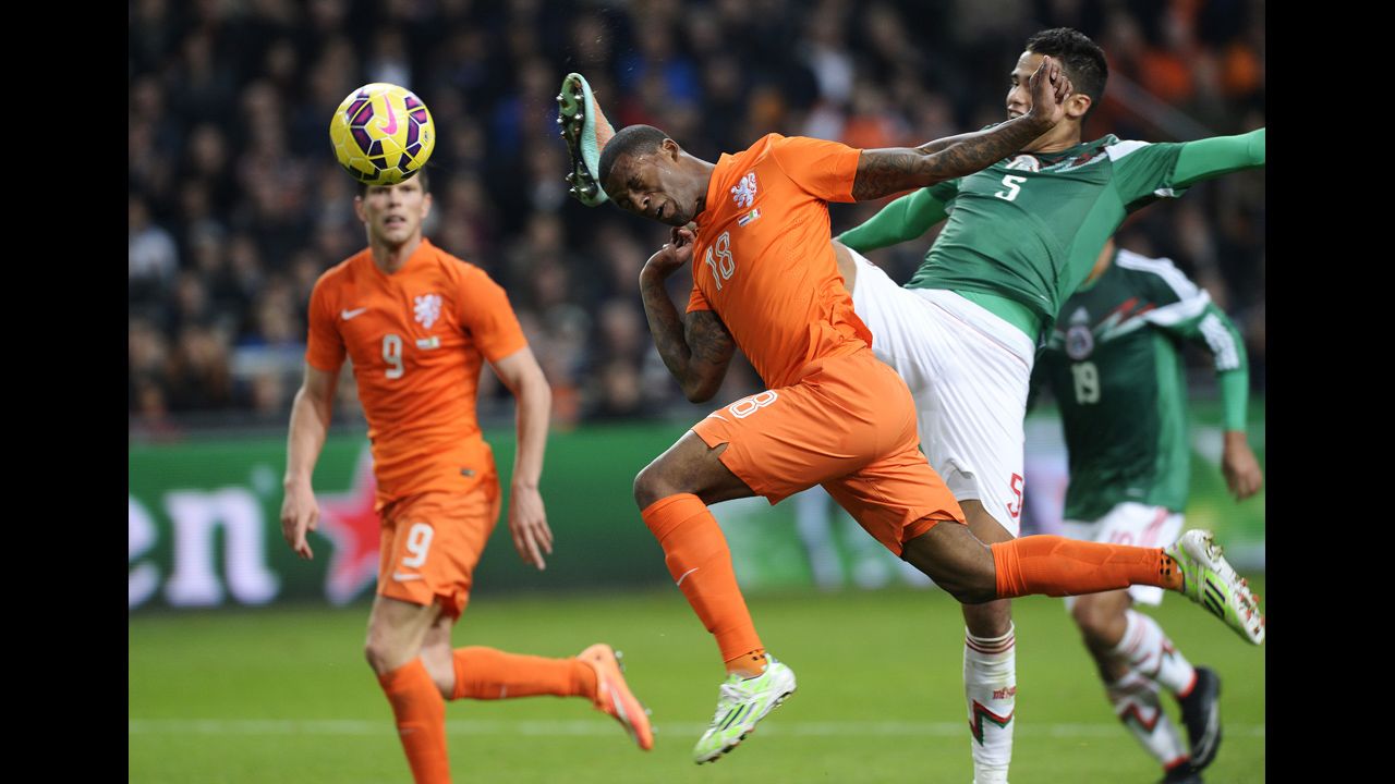 Dutch soccer player Georginio Wijnaldum, center, heads the ball as he challenges Mexico's Diego Reyes during an international friendly played Wednesday, November 12, in Amsterdam, Netherlands. Mexico won 3-2.