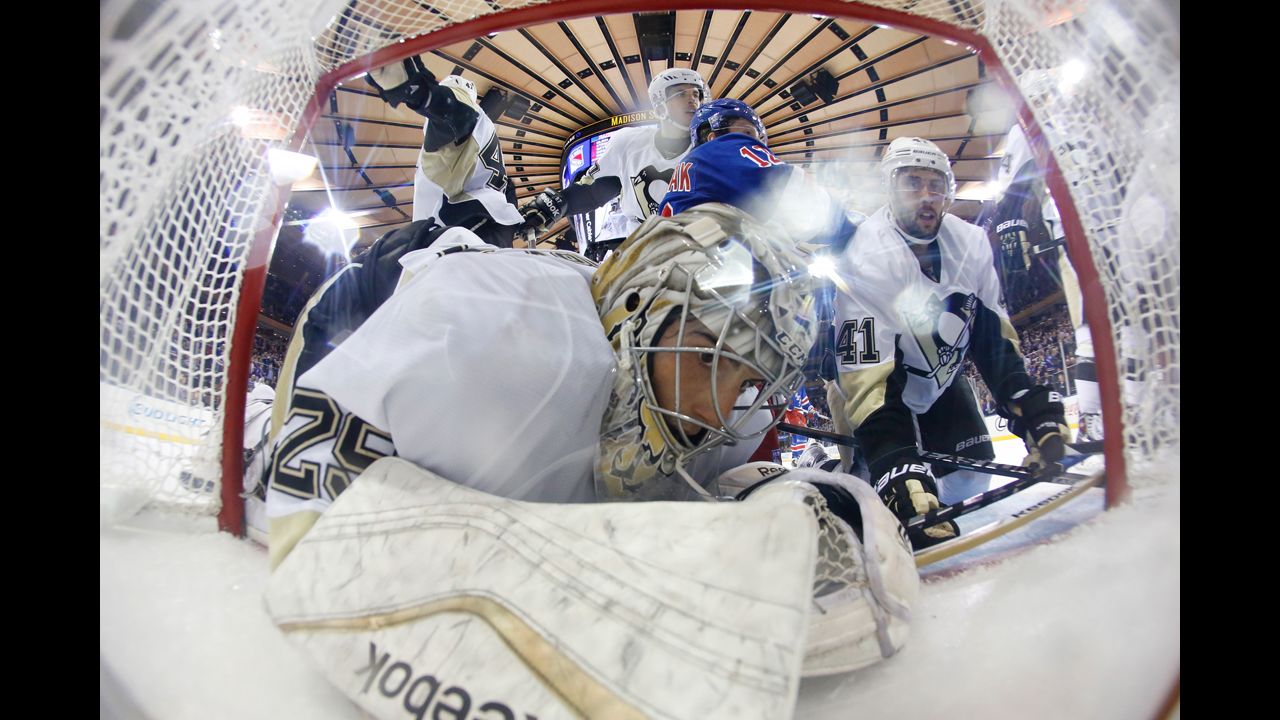 Pittsburgh goalie Marc-Andre Fleury is knocked into the net during an NHL game in New York on Tuesday, November 11.