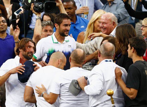 Cilic and a visibly-drained Ivanisevic celebrate with their support team following the world No. 9's first grand slam victory. 