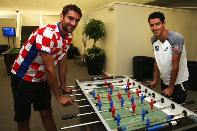 A keen AC Milan fan, Cilic wears his Croatia top with pride as he plays table football with fellow tennis pro Andre Sa of Brazil on the day the two teams opened the 2014 World Cup. The South Americans would win 3-1 hours later in Sao Paulo. 