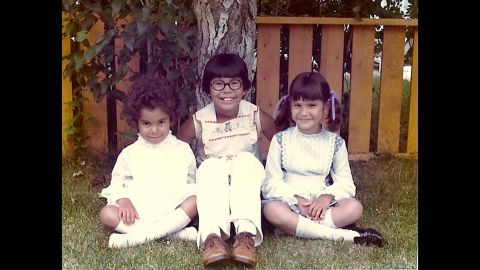 I pose for a snapshot with Darlene and Sheila under a tree in our backyard, wearing our Sunday best. Don't trust the angelic smiles.