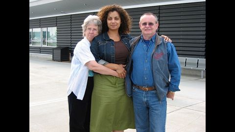 Mom, Dad and me pictured outside an airport; I was leaving to go back to whatever city I was living in at the time. You can see the sadness on my face. It's tough being so far away from them.