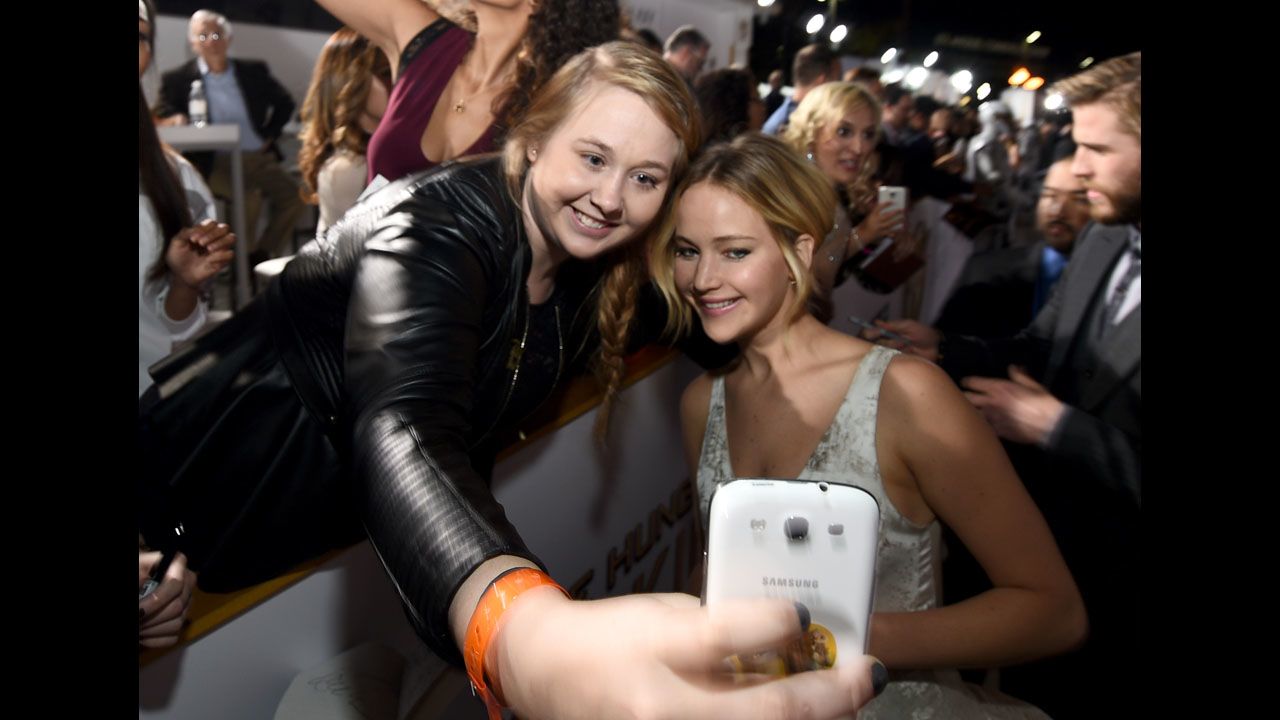 Actress Jennifer Lawrence, right, poses with fan Chelsea Boyce at the release of the latest "Hunger Games" movie Monday, November 17, in Los Angeles.
