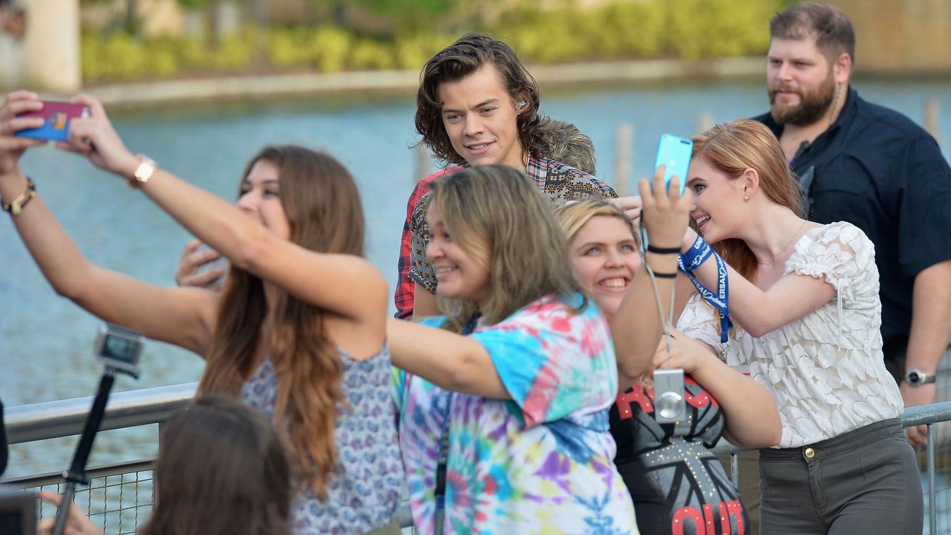 Fans in Orlando, Florida, take photos in front of One Direction star Harry Styles on Monday, November 17. Styles was appearing on NBC's "Today" show to promote the band's new album, "Four."