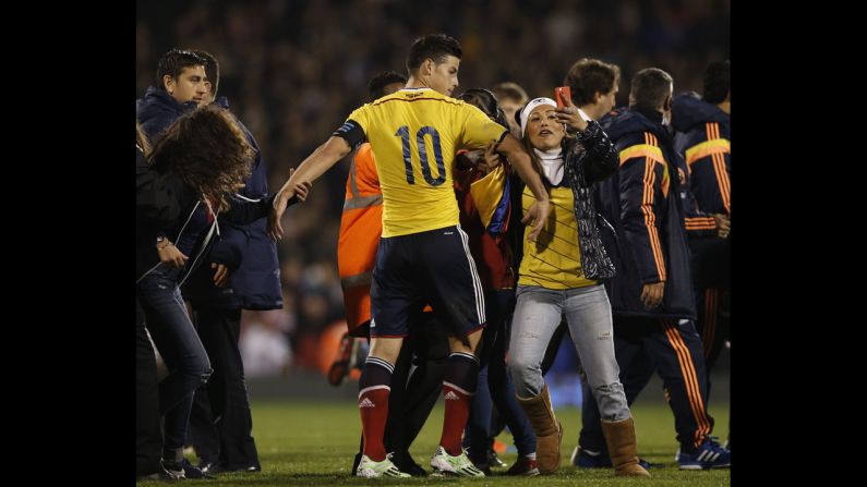 A soccer fan grabs Colombia's James Rodriguez after Colombia defeated the United States 2-1 in London on Friday, November 14.