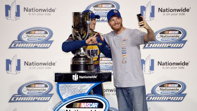 After winning a Nationwide Series race in Homestead, Florida, NASCAR driver Chase Elliott, left, poses with team owner Dale Earnhardt Jr. on Saturday, November 15. Elliott is the son of NASCAR great Bill Elliott. 