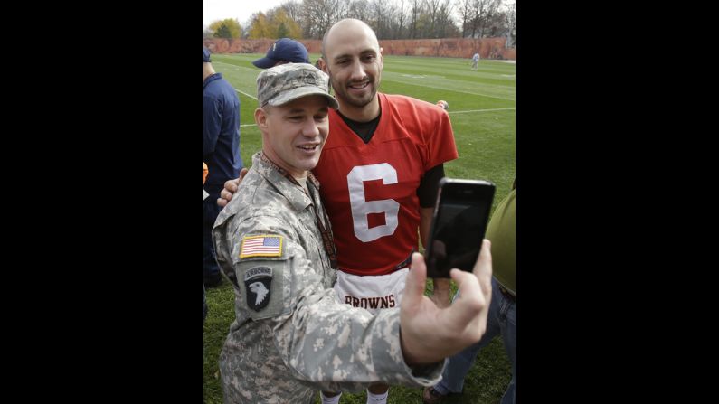U.S. Army soldier Jeremy King gets a photo with Cleveland Browns quarterback Brian Hoyer at a Browns practice on Tuesday, November 11. As part of the Salute to Service campaign, guests representing all five branches of the U.S. military were able to watch the Browns practice on Veterans Day.