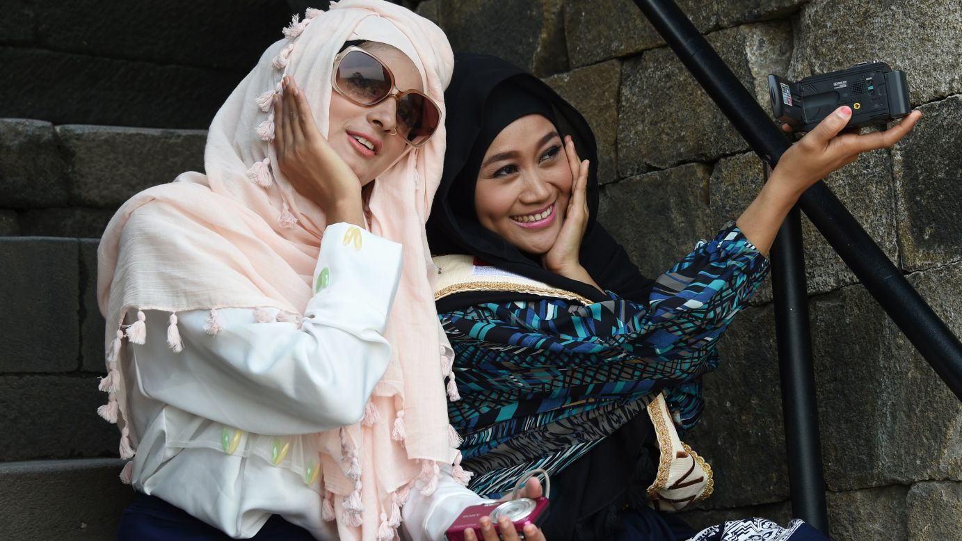 Two finalists for the World Muslimah Awards -- Nazreen, left, and Lulu Susanti -- take a picture together while touring the ancient Borobudur temple in Magelang, Indonesia, on Monday, November 17. About 25 women from around the world made the final round of the World Muslimah, a pageant exclusively for Muslim women.