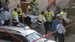 Israeli Zaka emergency services volunteers carry the body of a Palestinian assailant who was shot dead while attacking a synagogue in the ultra-Orthodox Har Nof neighbourhood in Jerusalem on November 18.