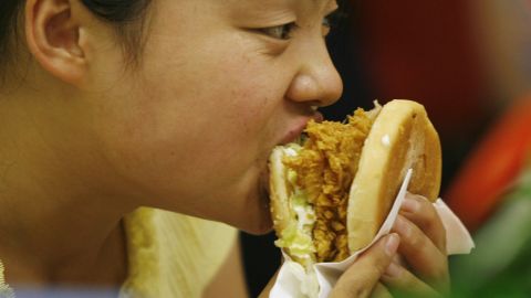  A woman eats a burger at a fast food restaurant in Beijing. China leads the world in diabetes, and in tuberculosis.. 