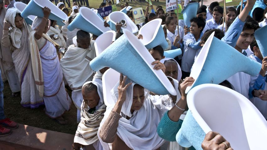 Indian women carry toilets on their heads during the opening ceremony of the three-day International Toilet Festival in New Delhi on November 18, 2014, the eve of World Toilet Day.