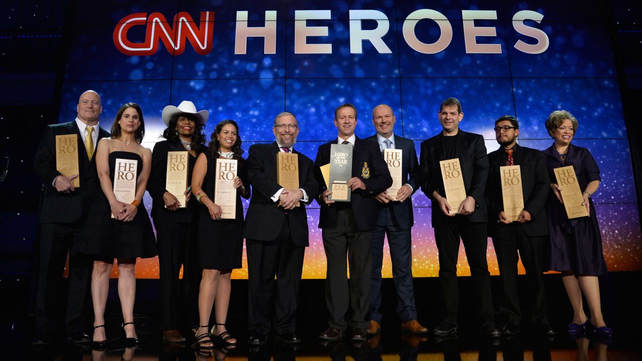 The top 10 CNN Heroes of the year pose on stage with their awards during the annual tribute show in New York.