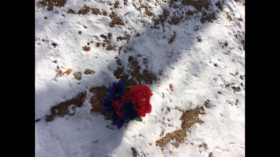 A small bouquet of plastic flowers marks the grave of Michael Brown in St. Peter's Cemetery.