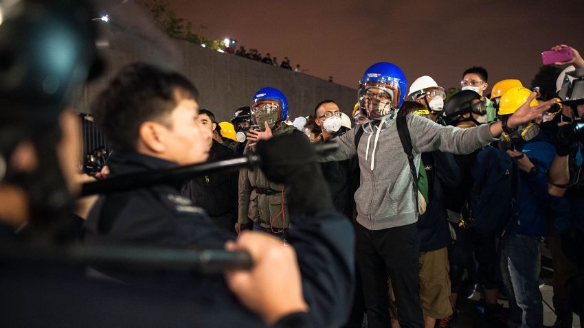 Pro-democracy protesters stand off with police officers outside the Legislative Council building after clashes on November 19.