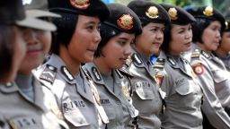 Indonesian policewomen stand guard while Indonesian workers of the All-Indonesia workers union (SPSI) hold a protest against the government's plan to hike fuel prices in Jakarta on March 29, 2012. Thousands of Indonesian protesters rallied on March 29 against a planned fuel price hike, ahead of a decision on cutting subsidies which the government says the nation can't afford. AFP PHOTO / ADEK BERRY (Photo credit should read ADEK BERRY/AFP/Getty Images)