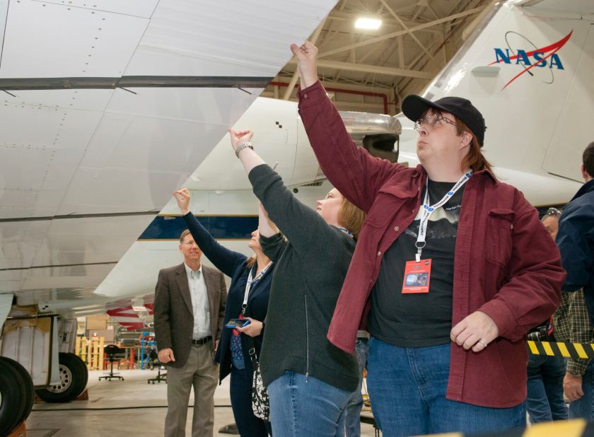 Attendee Trina Phillips (right) inspects an adaptive compliant trailing edge flap on a Gulfstream III flight research support aircraft.